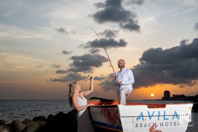 Couple fishing at sunset during their wedding celebration at Avila Beach Hotel in Curacao