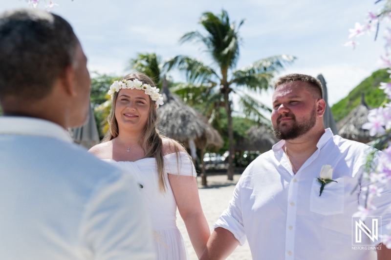 A Couple Exchanges Vows During an Outdoor Beach Wedding Ceremony Under the Sun, Surrounded by Palm Trees and Tropical Decorations