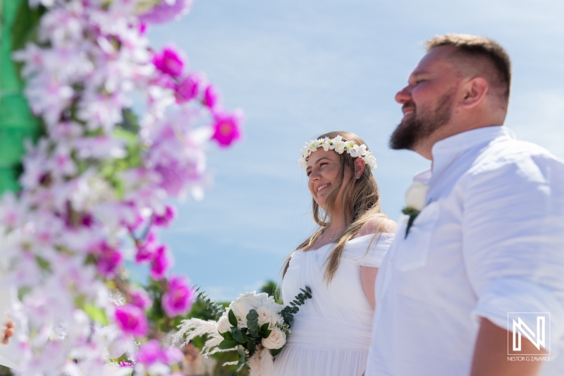 A Joyful Couple Exchanges Vows in a Beautiful Outdoor Ceremony Surrounded by Flowers and Sunlight on a Warm Summer Day