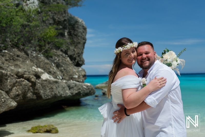 A Joyful Couple Celebrates Their Wedding on a Picturesque Beach, Surrounded by Turquoise Waters and Lush Greenery Under a Clear Blue Sky