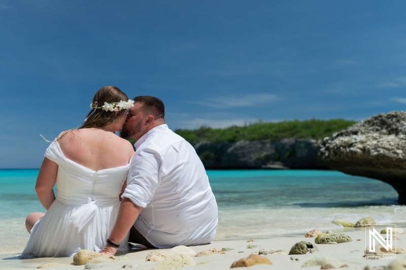 Couple Enjoying a Romantic Moment on a Tropical Beach During Their Wedding Ceremony, Surrounded by Clear Blue Waters and Sunny Skies