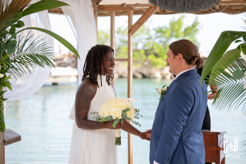 Ceremonial exchange at a tropical wedding in Curacao's Baoase Luxury Resort under a beautiful sunlit sky