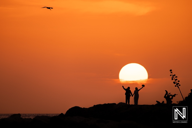 Couple celebrates their wedding against a stunning sunset backdrop at Baoase Luxury Resort in Curacao