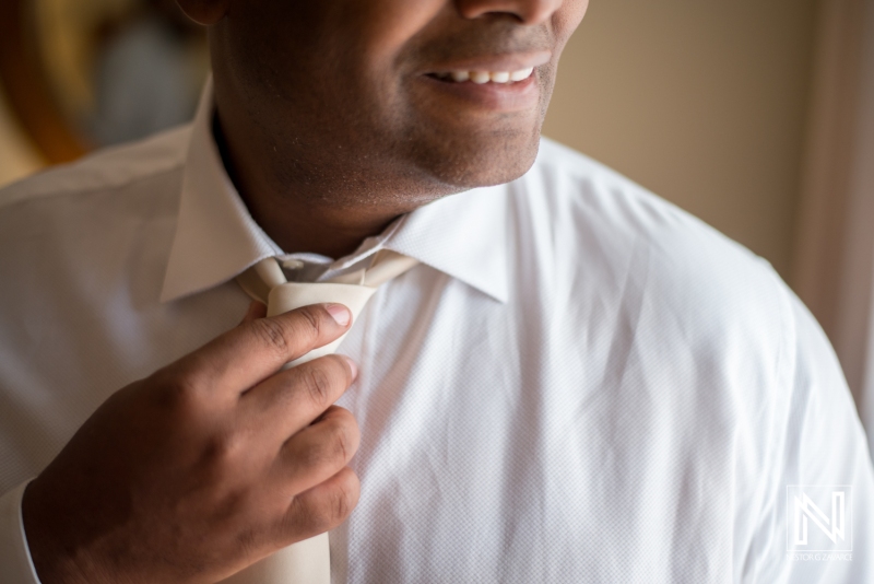 Groom getting into attire
