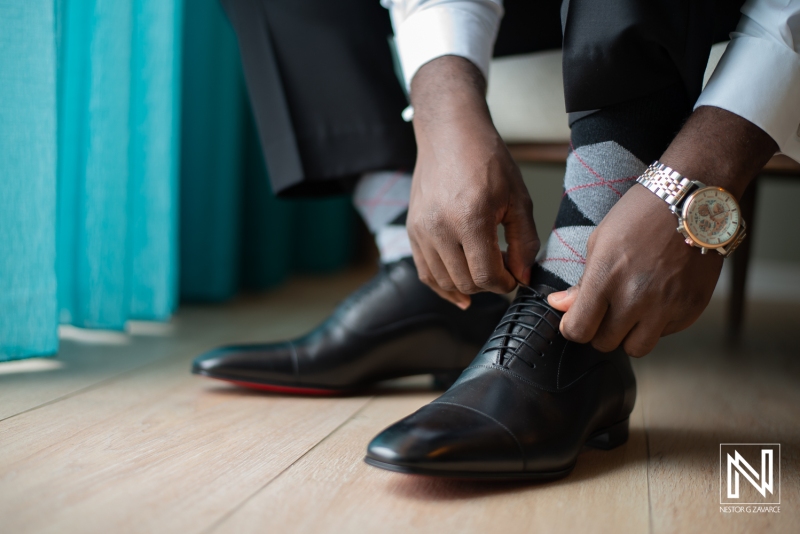 Groom wearing his shoes