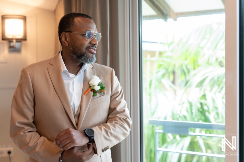 Groom prepares for a beautiful wedding at Avila Beach Hotel in Curacao with stunning ocean views