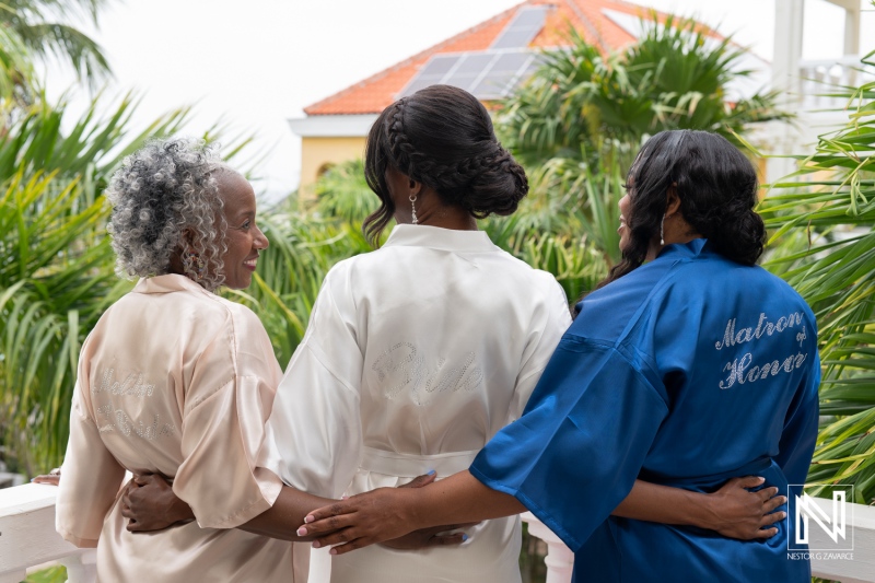 Bridesmaids enjoying a moment together before the destination wedding at Avila Beach Hotel in Curacao