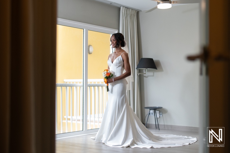 Beautiful bride prepares for destination wedding at Avila Beach Hotel in Curacao surrounded by vibrant island scenery