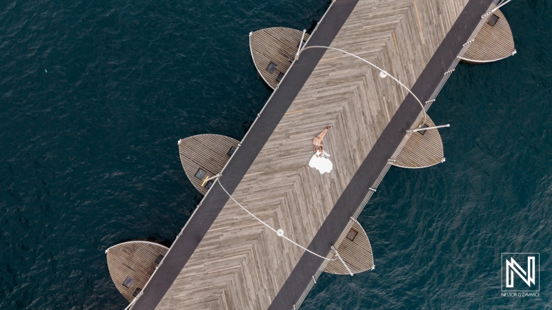 Couple celebrates their wedding on a pier at Avila Beach Hotel in Curacao, surrounded by the serene sea and beautiful scenery