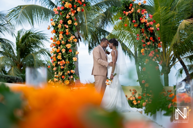 Wedding ceremony at Avila Beach Hotel in Curacao with stunning floral decorations and a tropical backdrop