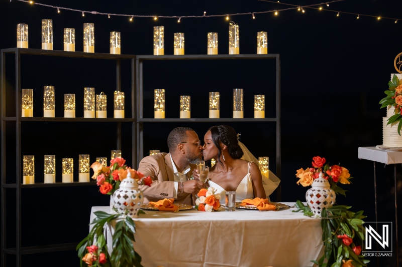Couple celebrates their love in a romantic setting at Avila Beach Hotel in Curacao during a sunset wedding reception