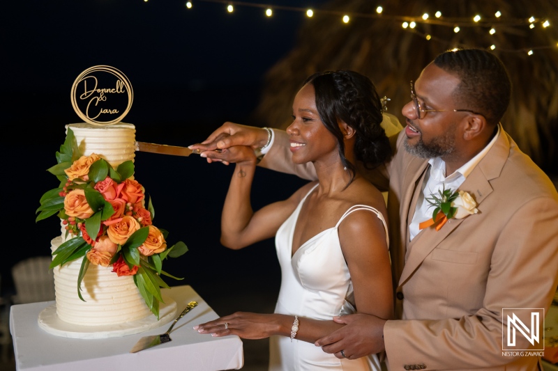 Romantic wedding celebration at Avila Beach Hotel in Curacao with cake cutting and beautiful decorations