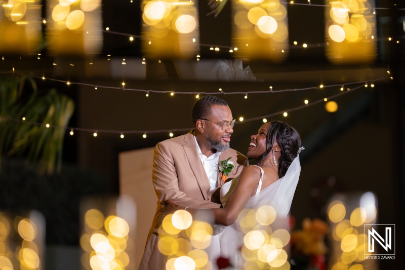 Beautiful wedding celebration at Avila Beach Hotel in Curacao with joyful couple under glowing lights