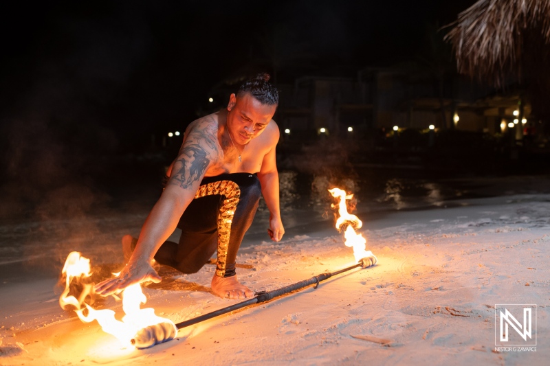 Fire dancer performs on the beach during a destination wedding at Avila Beach Hotel in Curacao