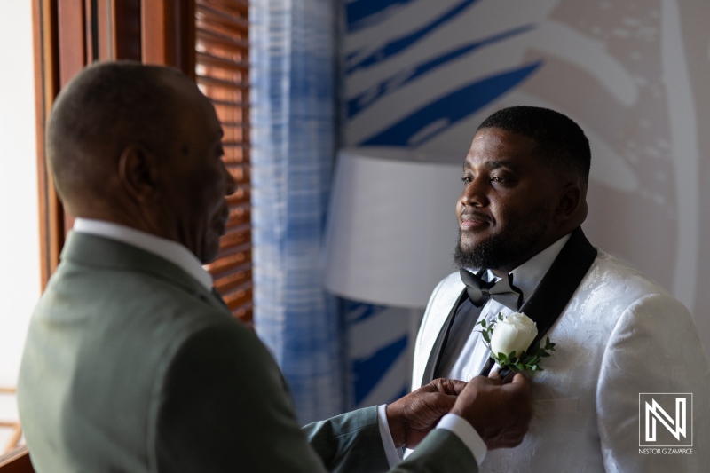 Groom Receiving a Boutonnière From His Father in a Well-Lit Hotel Room Before the Wedding Ceremony in the Early Afternoon