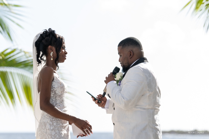 A Couple Exchanges Vows During a Beautiful Beach Wedding Ceremony Under Clear Skies and Swaying Palm Trees in a Tropical Paradise