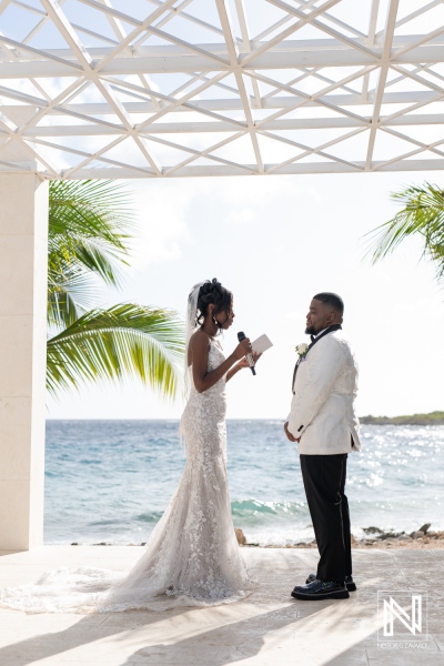 Couple Exchanging Wedding Vows at a Beachside Venue With Tropical Palms, Capturing a Romantic Moment During a Sunset Ceremony