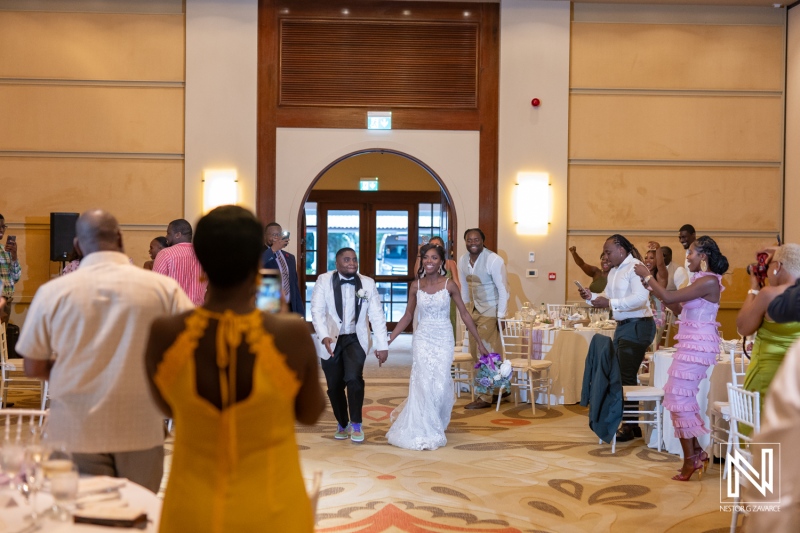 A Joyful Wedding Celebration With a Couple Entering the Reception Venue Filled With Family and Friends, Showcasing an Elegant Atmosphere and Heartfelt Camaraderie