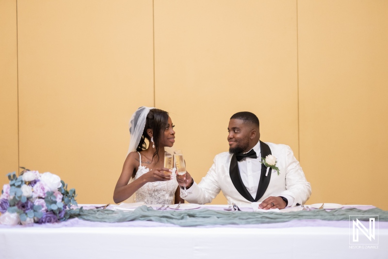 A Joyful Newlywed Couple Toasting With Champagne During Their Wedding Reception at a Decorated Banquet Hall in the Evening