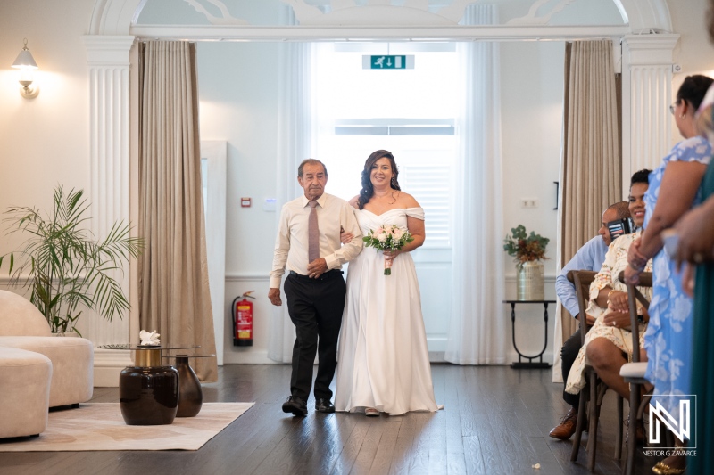 Beautiful wedding ceremony in Kranshi, Curacao with bride walking down the aisle with her father