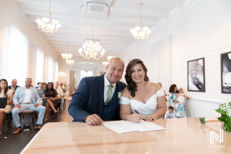 Wedding ceremony celebration at Kranshi in Curacao with joyful couple signing their marriage certificate