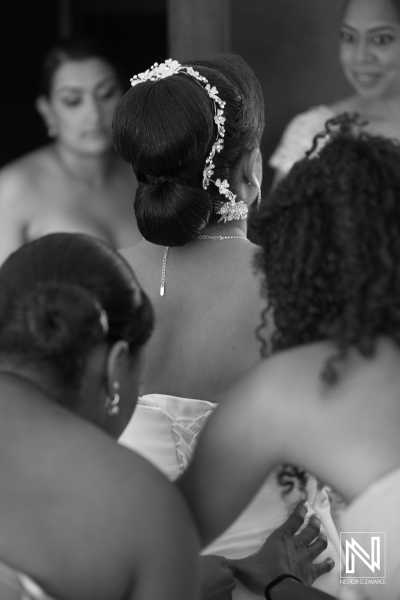 Bridesmaid hepling the bride to dress