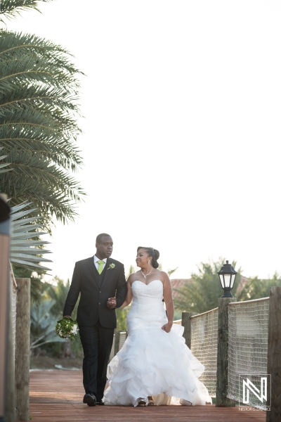 Bride and groom walking on the pier