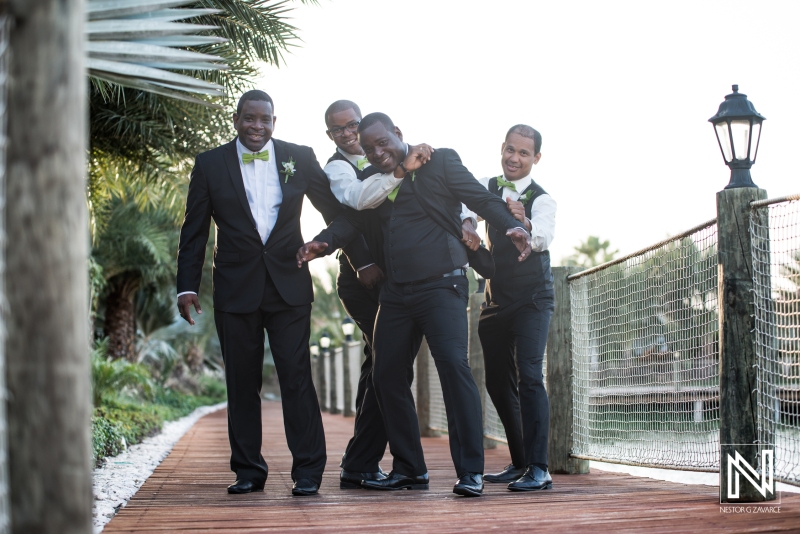 Groomsmen holding the groom on the lagoon pier