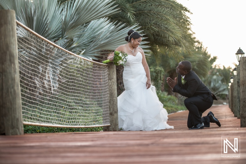 Groom asking for a kiss on the pier