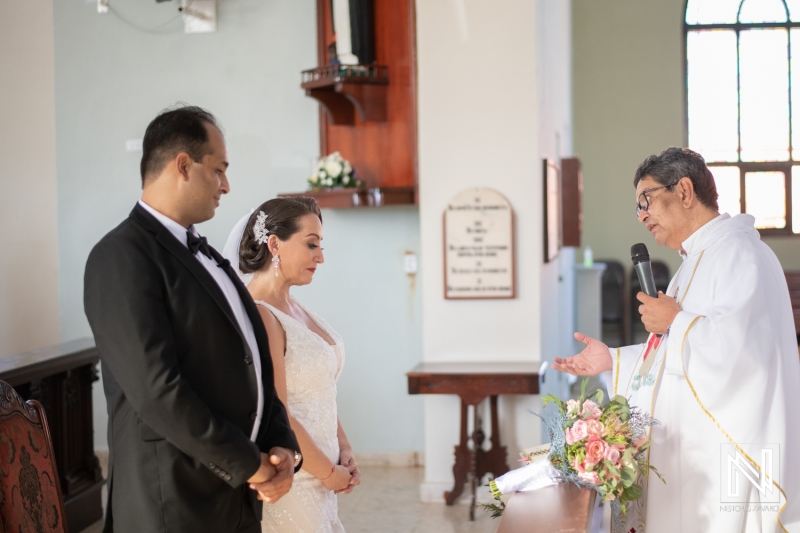 Bride and groom blessed by pastor
