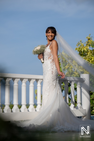Wedding celebration at Playa Hunku in Curacao with a bride holding flowers