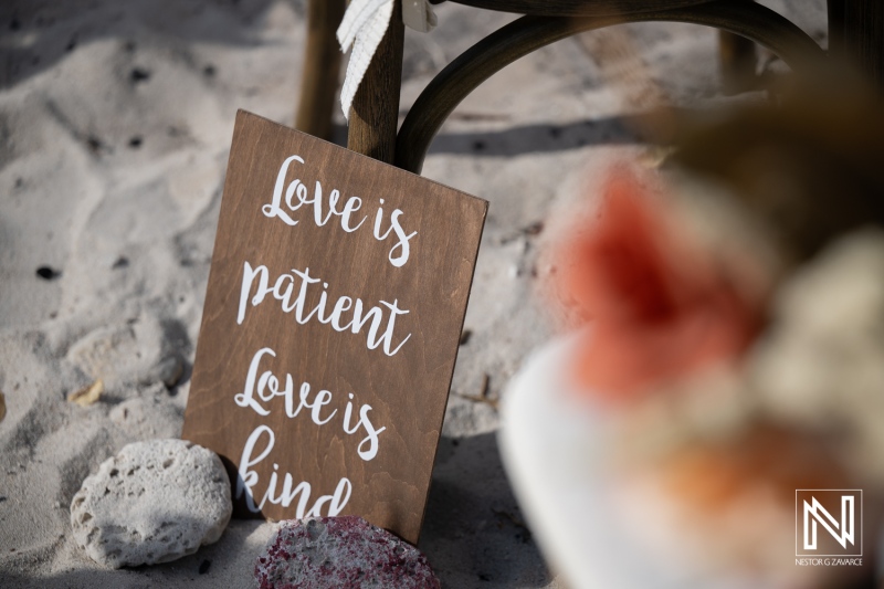 Wedding ceremony at Playa Hunku in Curacao includes a love sign on the sand