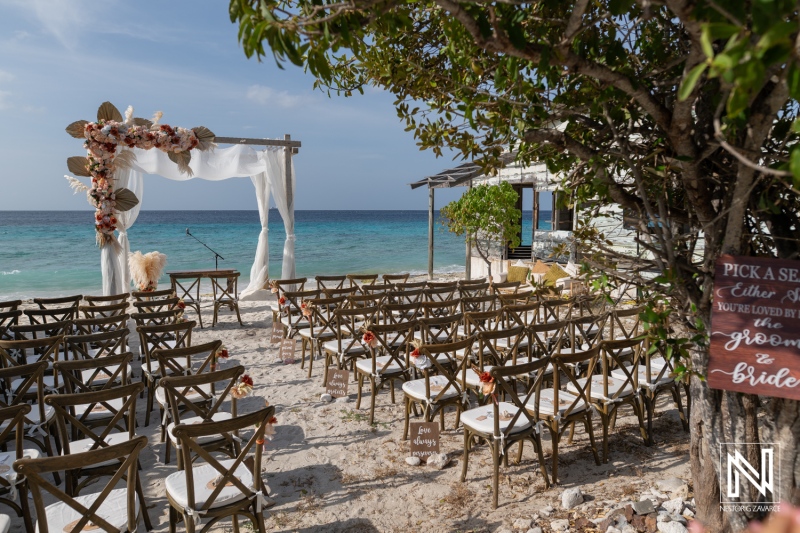 Wedding ceremony setup at Playa Hunku in Curacao with chairs and floral decorations