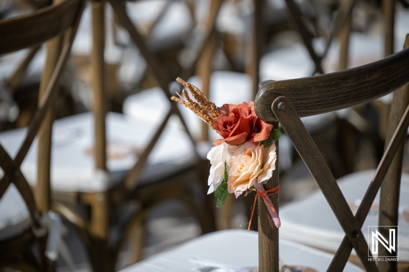 Wedding setup at Playa Hunku in Curacao with floral decorations on chairs