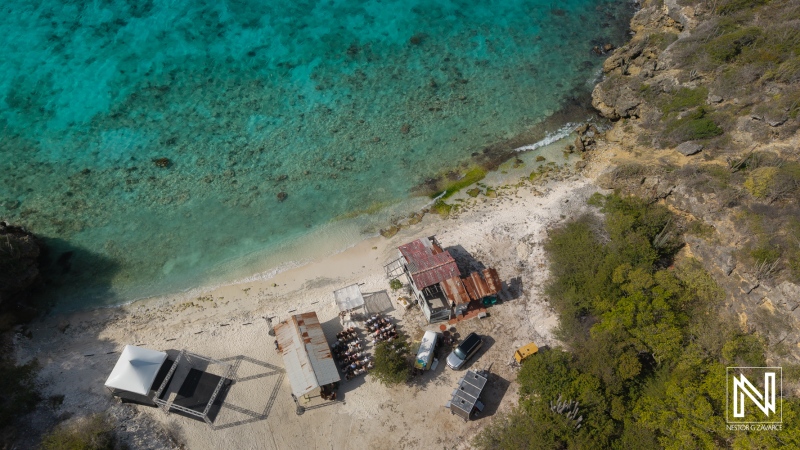 Wedding ceremony taking place at Playa Hunku in Curacao near the ocean and surrounded by rocky areas