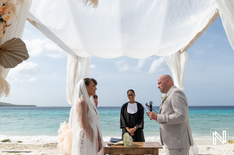 Wedding ceremony at Playa Hunku in Curacao takes place by the beach on a sunny day