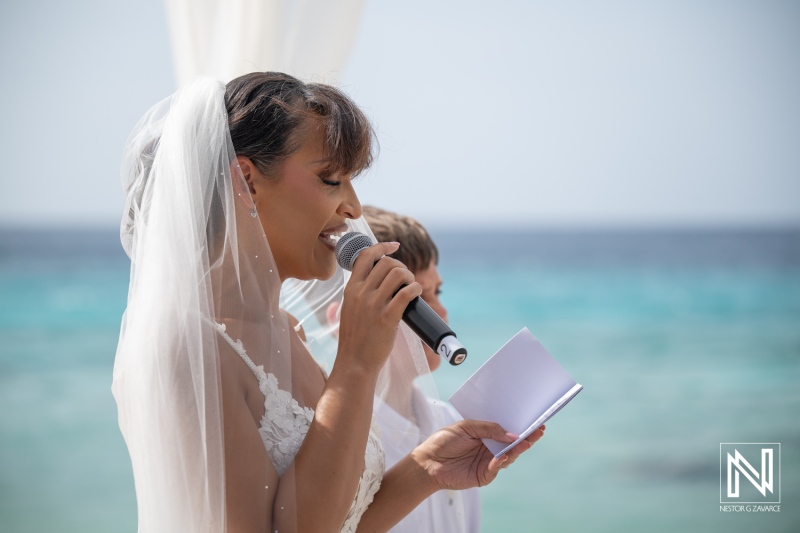 Couple exchanges vows during wedding ceremony at Playa Hunku in Curacao