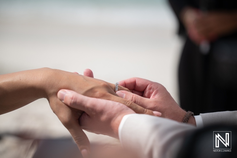 Couple exchanges wedding rings during ceremony at Playa Hunku in Curacao