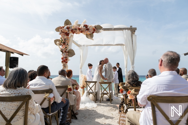 Wedding ceremony at Playa Hunku in Curacao with guests witnessing vows on the beach