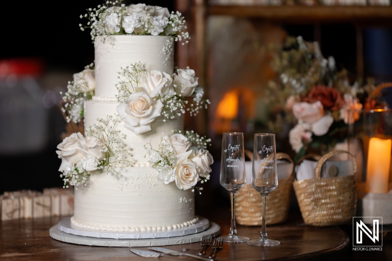 Wedding cake and champagne flutes at Playa Hunku during a wedding celebration