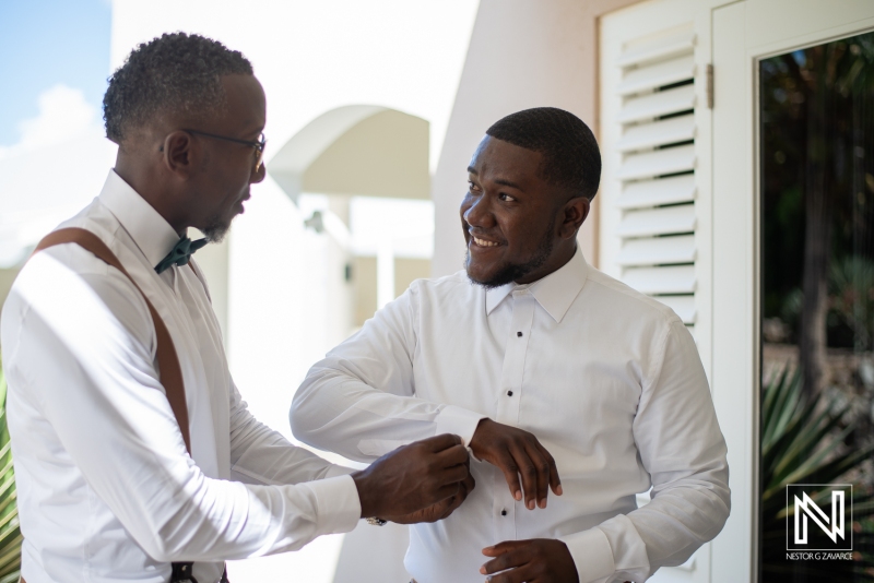Groomsmen helping the groom to get ready