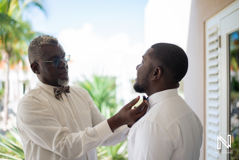 Dad of the groom helping him to get ready
