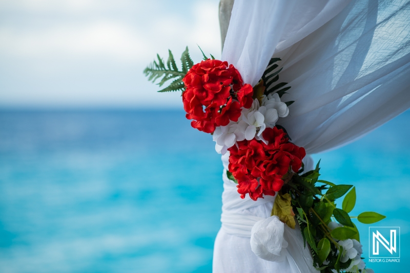 Wedding beach decoration with red and white flowers