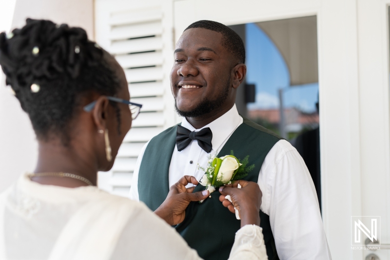 Mom of the groom putting the boutonniere