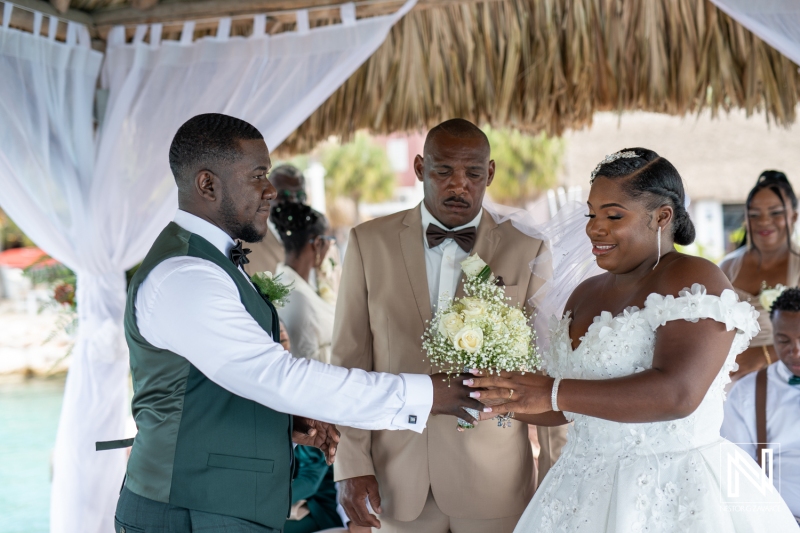 Groom giving the bouquet to the bride