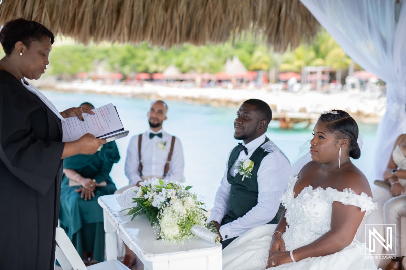 Bride and groom atteding in the civil ceremony at the beach