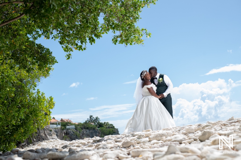 Bride and groom photoshoot at the beach with coral rocks