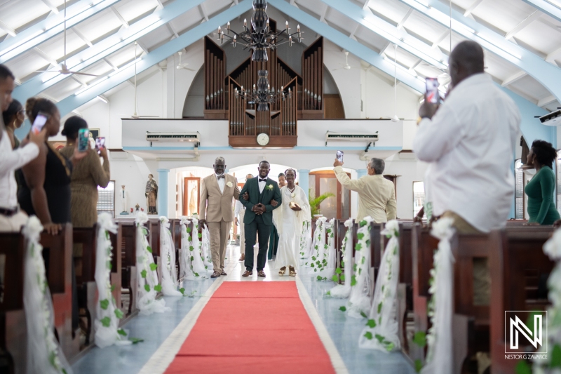 Groom walking the aisle with him parents