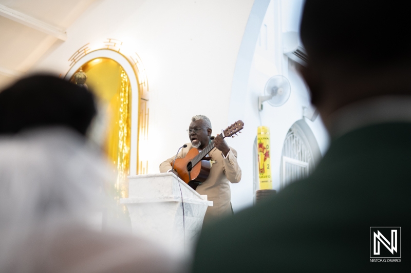 Man singing and playing the guitar at the wedding ceremony