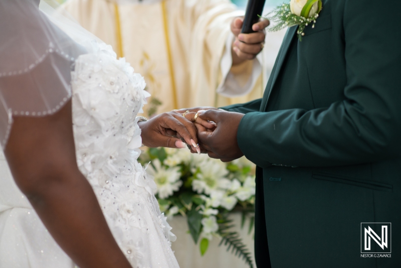 Bride and groom exchanging wedding rings in the church ceremony